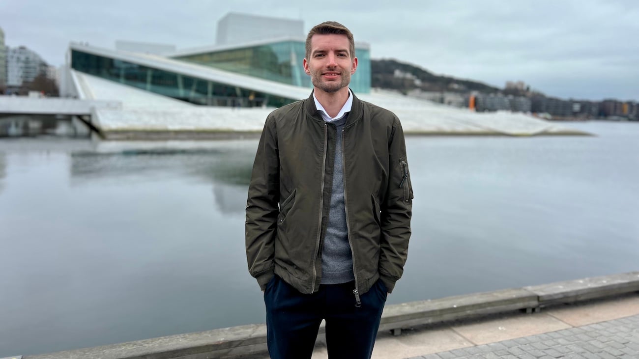 Utendørs portettbilde av mann med hendene i lommen forran Oslo operaen